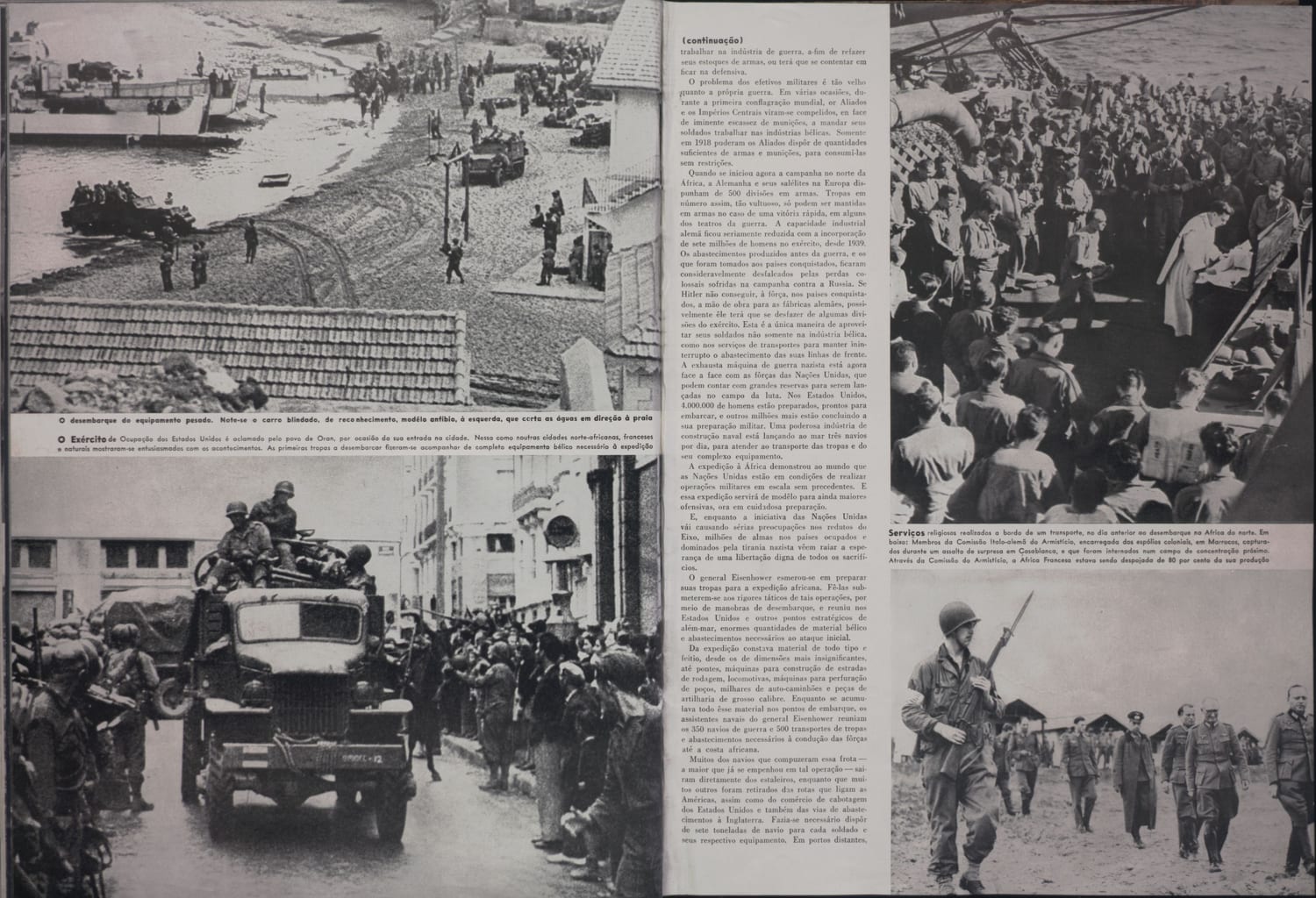 Fotografia mostrando desembarque de equipamento militar pesado e veículos blindados na praia durante operação anfíbia.